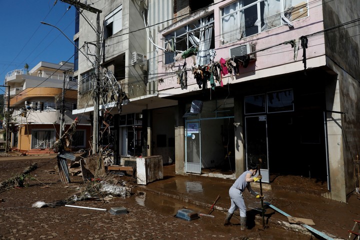 A resident cleans up a flood-affected area after an extratropical cyclone hit southern towns, in Mucum, Rio Grande do Sul, Brazil, September 6, 2023. REUTERS/Diego Vara