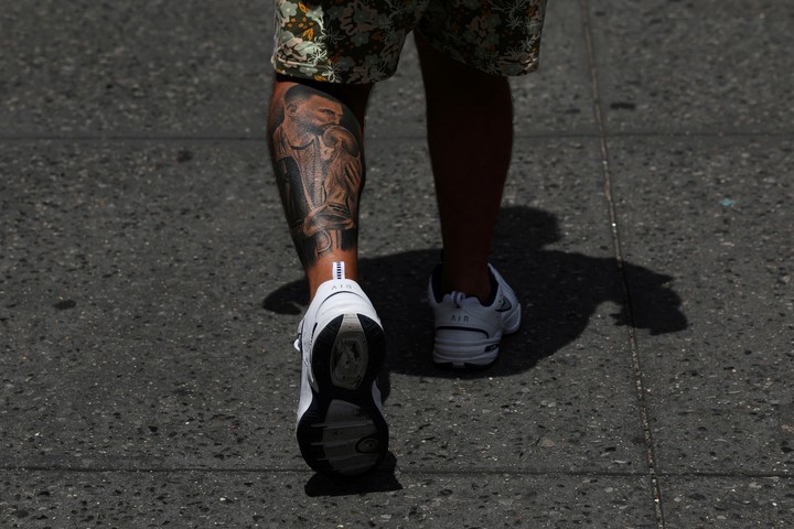 A fan of Argentina's Lionel Messi walks with a tattoo honoring the player in the Chinatown area of New York City, U.S., July 10, 2024. REUTERS/Shannon Stapleton