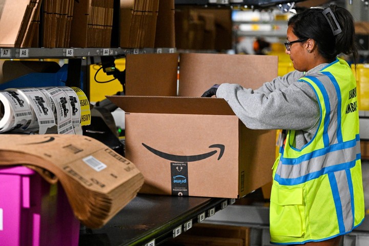 A worker packages products during a media tour of the Amazon.com Inc. DAB2 fulfillment center in Daytona Beach, Florida, US.